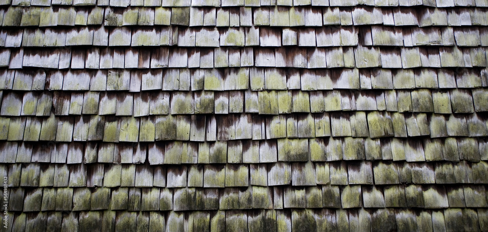 a house wall covered with small wooden tiles,gray background for design a house wall covered with small wooden tiles,gray background for design