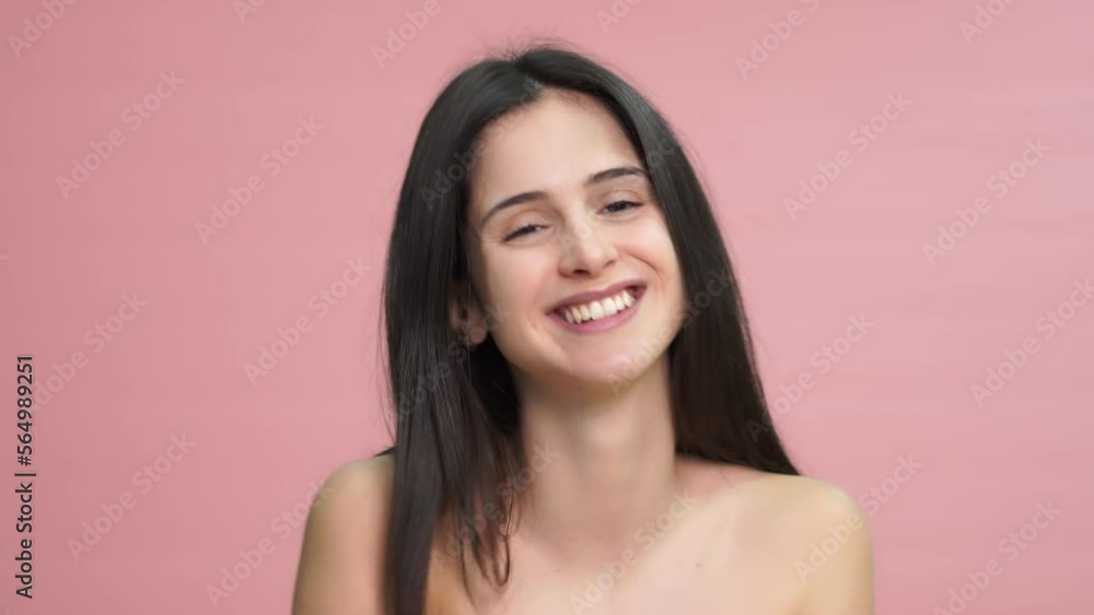 Smiling woman with closed eyes on pink background Smiling woman with closed eyes on pink background