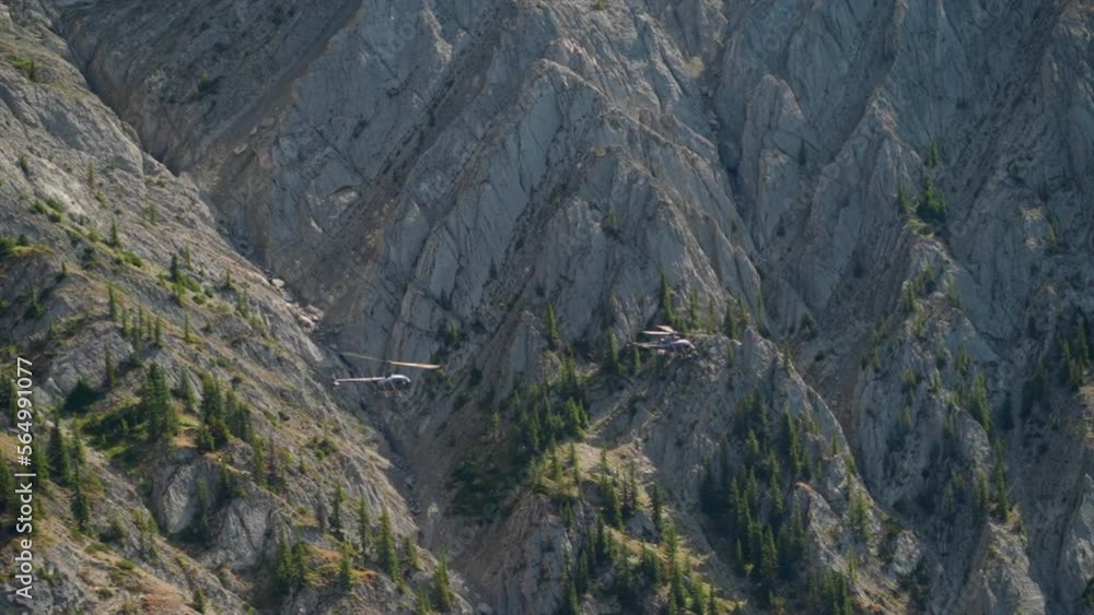 A thrilling helicopter tour of the Canadian Rocky Mountains, breathtaking aerial views of snow-capped peaks, glaciers, rivers, and forests. Wilderness from a bird's-eye view visible from above. A thrilling helicopter tour of the Canadian Rocky Mountains, breathtaking aerial views of snow-capped peaks, glaciers, rivers, and forests. Wilderness from a bird's-eye view visible from above.
