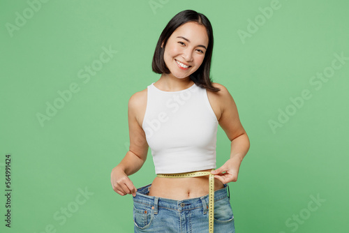 Bilde på lerret Young woman wear white clothes show loose pants after weightloss hold measure ta