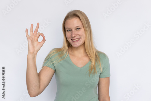 Wallpaper Mural Happy woman showing ok gesture. Young female model making ok sign. Portrait, studio shot, quality, support concept Torontodigital.ca