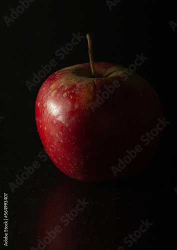 Red apple on black background