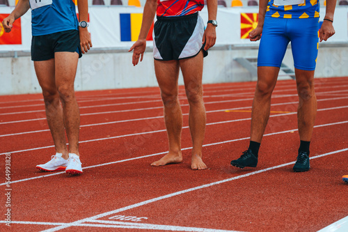 Barefoot Racing. Barefoot athlete captured at the starting line of a 1500m race, showcasing natural strength and agility