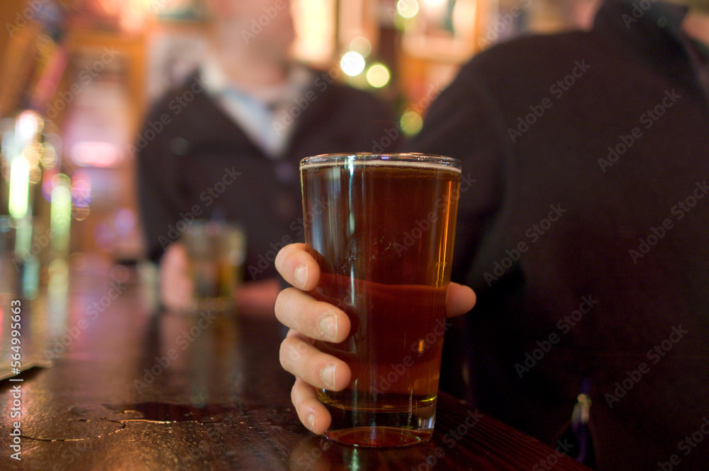Friends go out and have a few beers at a bar in Cambridge, boston. Friends go out and have a few beers at a bar in Cambridge, boston.