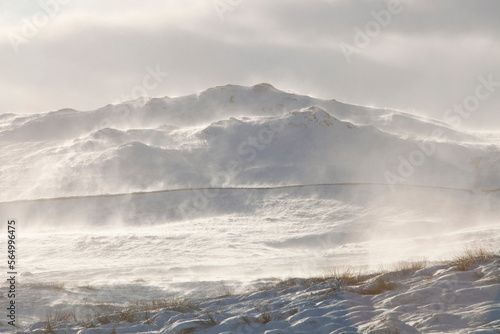 Wansfell on the side of Kirkstone Pass in the Lake District, looking like something out of the Antarctic with snow and spindrift being blown across the hill side, UK. photo