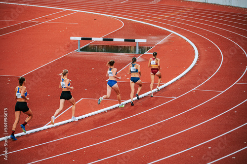 Powerful image of female athletes competing in long distance race. Suitable for fitness, athleticism and competition themed campaigns