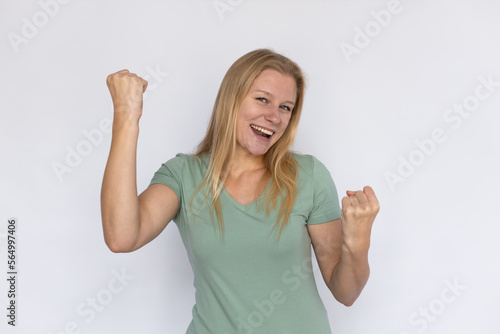 Wallpaper Mural Happy woman celebrating. Young female model with clenched fists celebrating victory. Portrait, studio shot, victory, success concept Torontodigital.ca