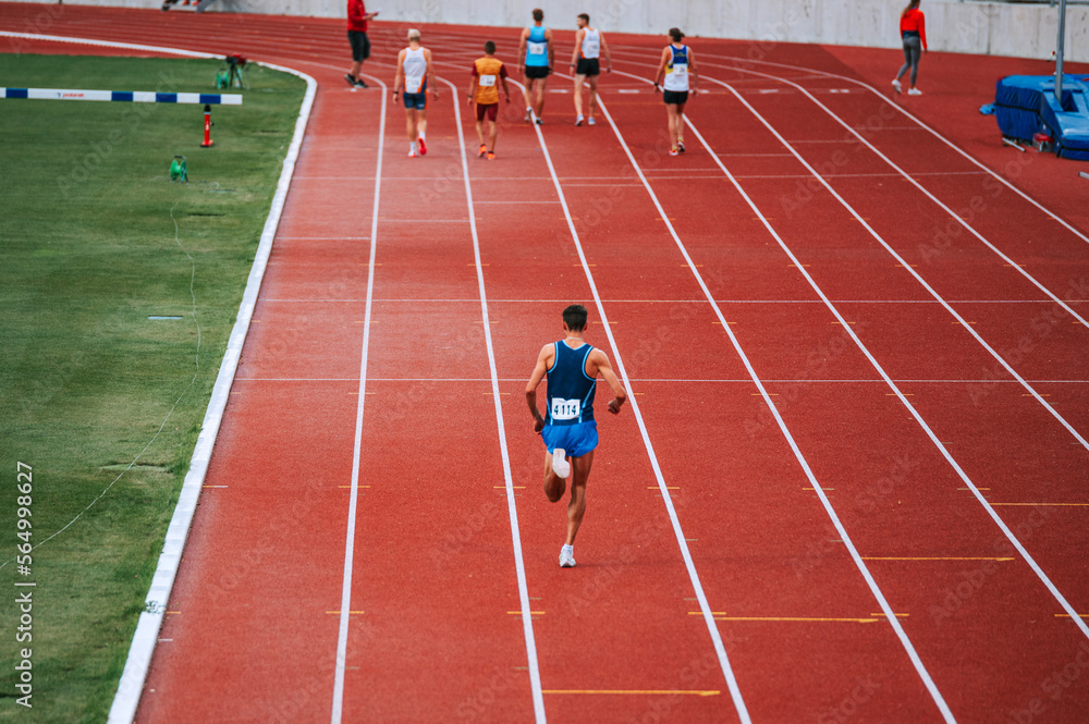 Image of long distance runners at the starting line of a 5000m race, promoting the benefits of training and exercise