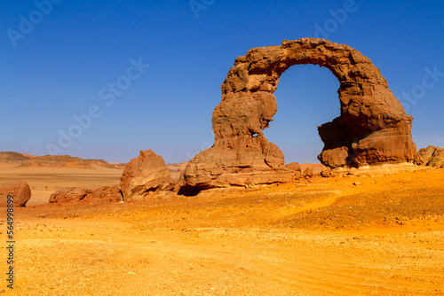 The huge, natural arch called "Arch of Tehak" in the Tadrart mountains. Tassili N'Ajjer National Park. Sahara, Algerian Desert. Illizi Province, Djanet, Algeria, Africa 