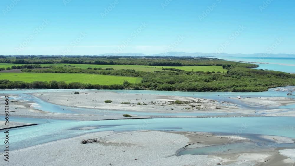 High aerial beside beautiful turquoise Rakaia River as it exits into ocean (New Zealand) High aerial beside beautiful turquoise Rakaia River as it exits into ocean (New Zealand)