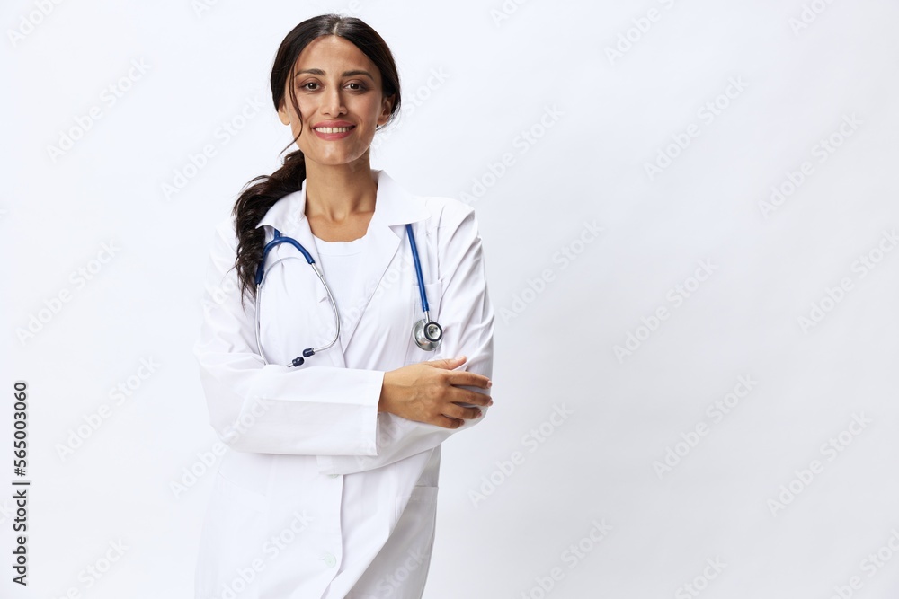 Woman doctor with stethoscope in hand in medical gown on white nurse background, consequences of covid-19, noise in lungs, concept of health and science Woman doctor with stethoscope in hand in medical gown on white nurse background, consequences of covid-19, noise in lungs, concept of health and science