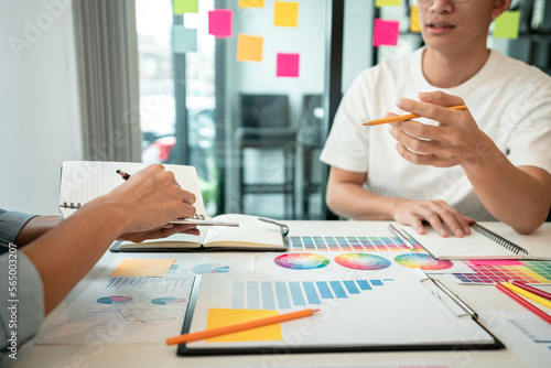 Team of creative graphic designer working on color swatch samples chart for selection coloring in inspiration to create new collection at workplace