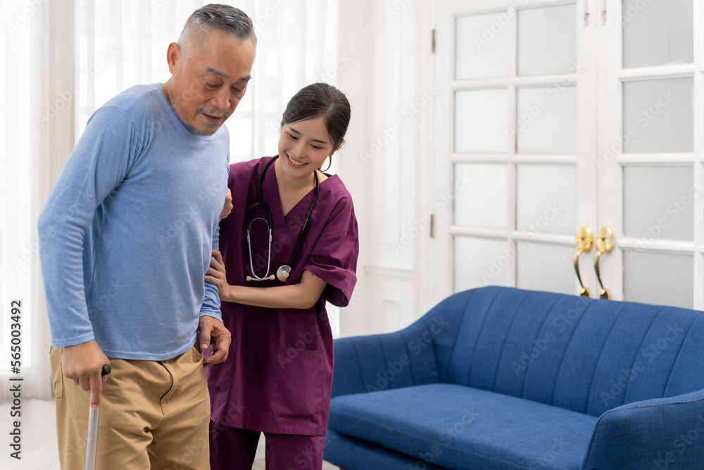 Senior man use cane as support during therapy to walking with physiotherapist Senior man use cane as support during therapy to walking with physiotherapist
