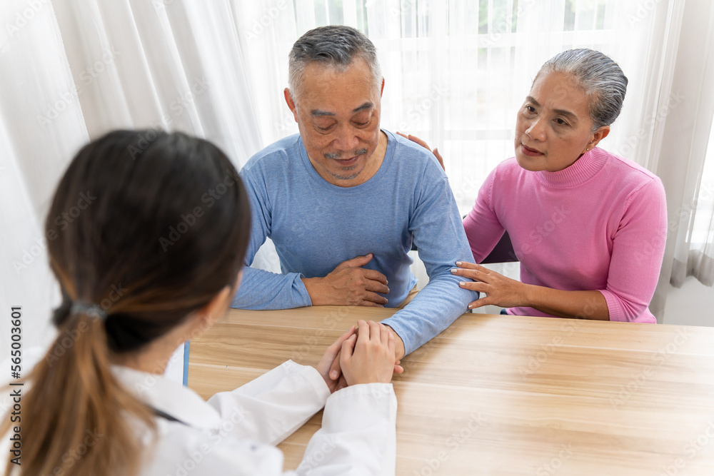 Fototapeta premium Young female doctor holding old man's hand to encourage