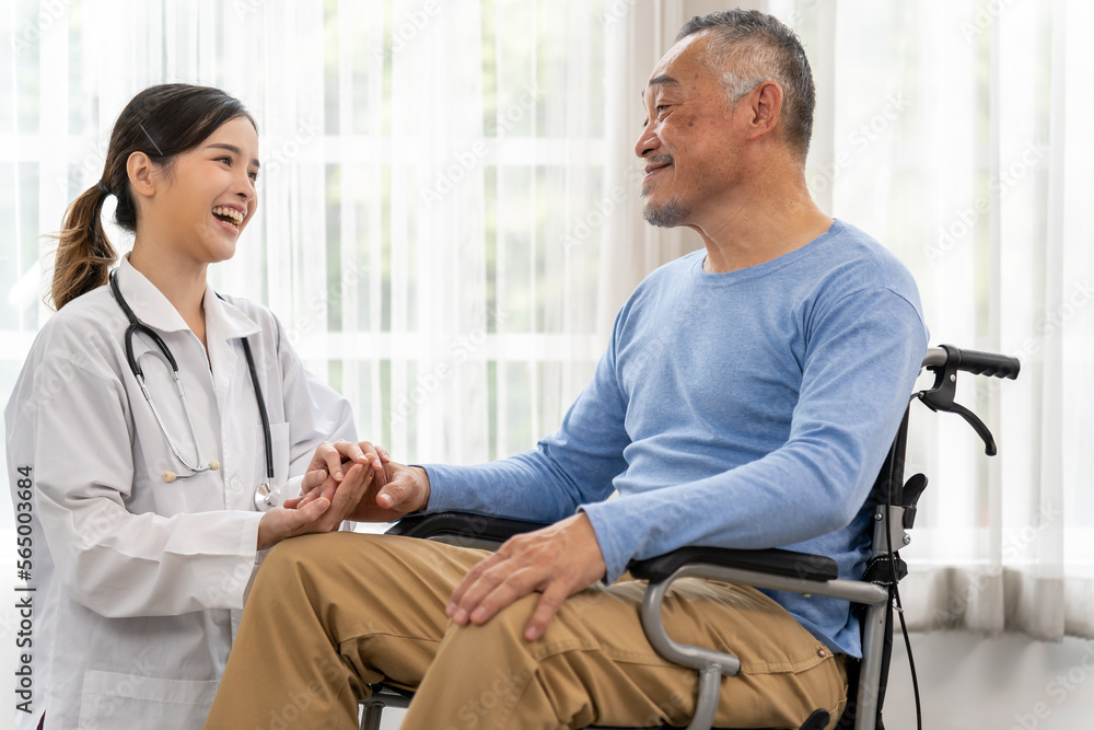 Young female doctor talking with old man in wheelchair to encourage Young female doctor talking with old man in wheelchair to encourage