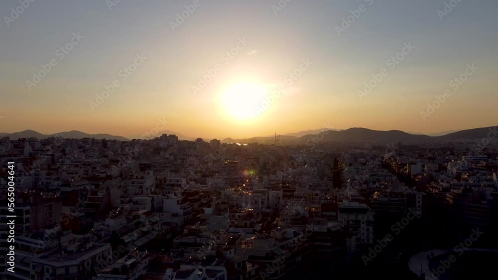 A breathtaking aerial shot of the sun setting over Pireaus, Greece. A breathtaking aerial shot of the sun setting over Pireaus, Greece.