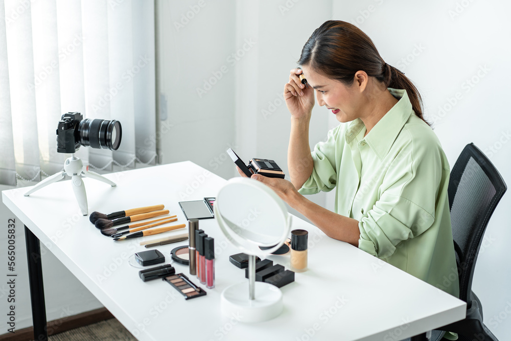 Woman blogger is showing present make up tutorial beauty cosmeti Woman blogger is showing present make up tutorial beauty cosmeti