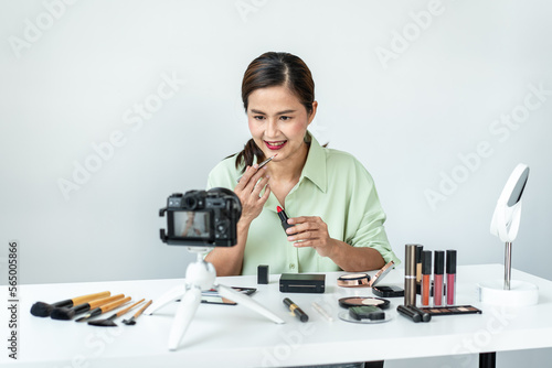 Woman blogger is showing present make up tutorial beauty cosmetic review product and broadcast live streaming video to social network teaching online on the camera screen