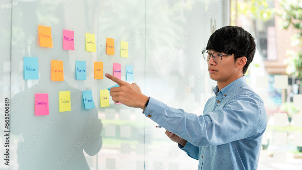 Businessman executive thinking and taking notes keyword on board Businessman executive thinking and taking notes keyword on board