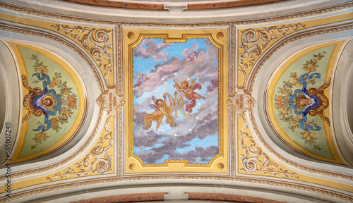 IVREA, ITALY - JULY 15, 2022: The ceiling fresco of angels with the marianic initials in the church Chiesa di San Salvatore by G. Silvestro (1914). photo
