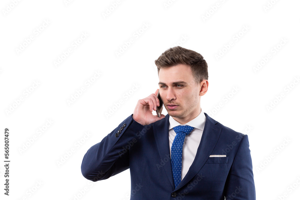 A young male businessman in a suit answers a call on a smartphone and has a business conversation. In the studio on a white background. A young male businessman in a suit answers a call on a smartphone and has a business conversation. In the studio on a white background.