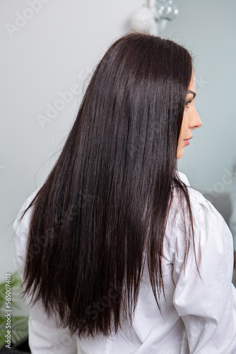 Beautiful young woman with long black hair in a beauty salon.