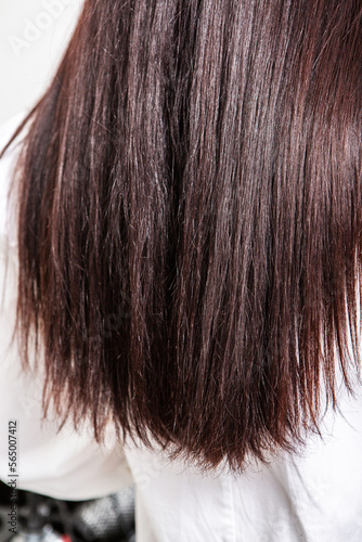 Beautiful young woman with long black hair in a beauty salon.