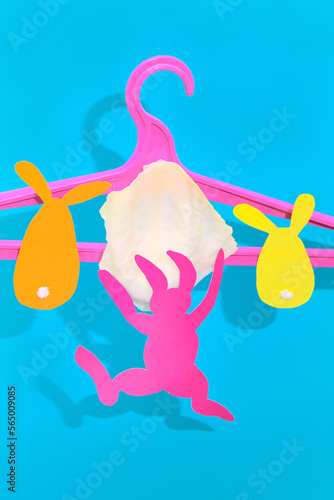 The rabbit is hanging from a cabbage on a clothes hanger. Easter Concept © Olek