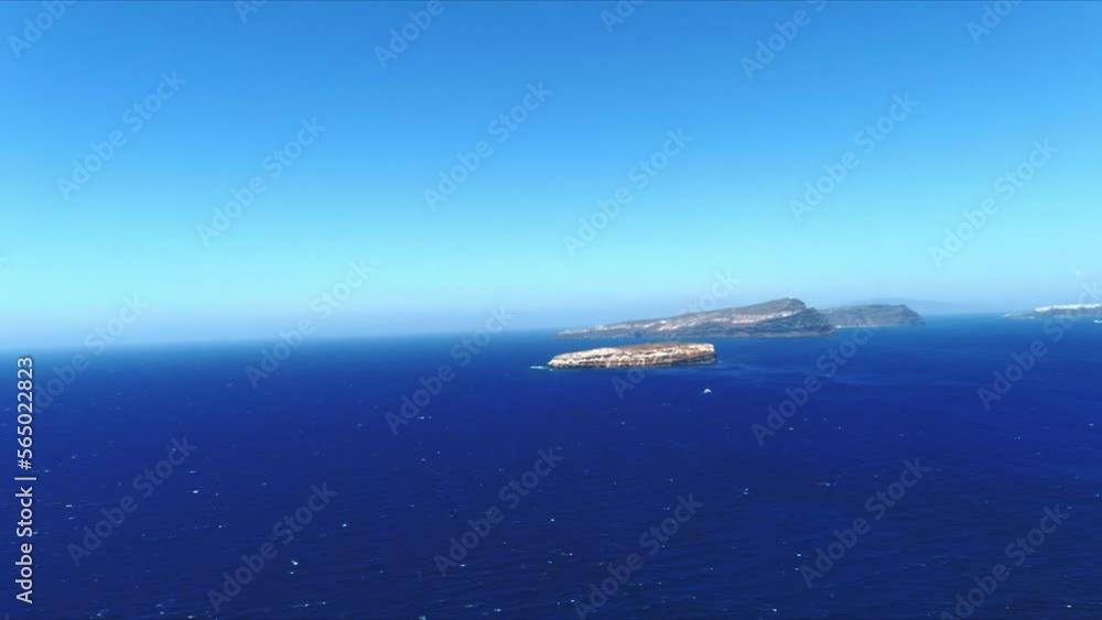 Aerial 4K Blue Sea and Sky Top View Towards Distant Tropical Islands in Santorini Greece Aerial 4K Blue Sea and Sky Top View Towards Distant Tropical Islands in Santorini Greece