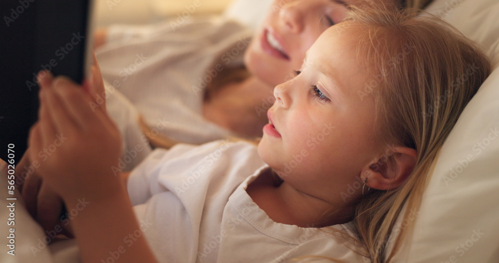 Tablet, mother and child on the internet in bed, streaming a movie or reading a book on the web at night. Education, learning and games on technology for a girl and her mom together in the bedroom Tablet, mother and child on the internet in bed, streaming a movie or reading a book on the web at night. Education, learning and games on technology for a girl and her mom together in the bedroom