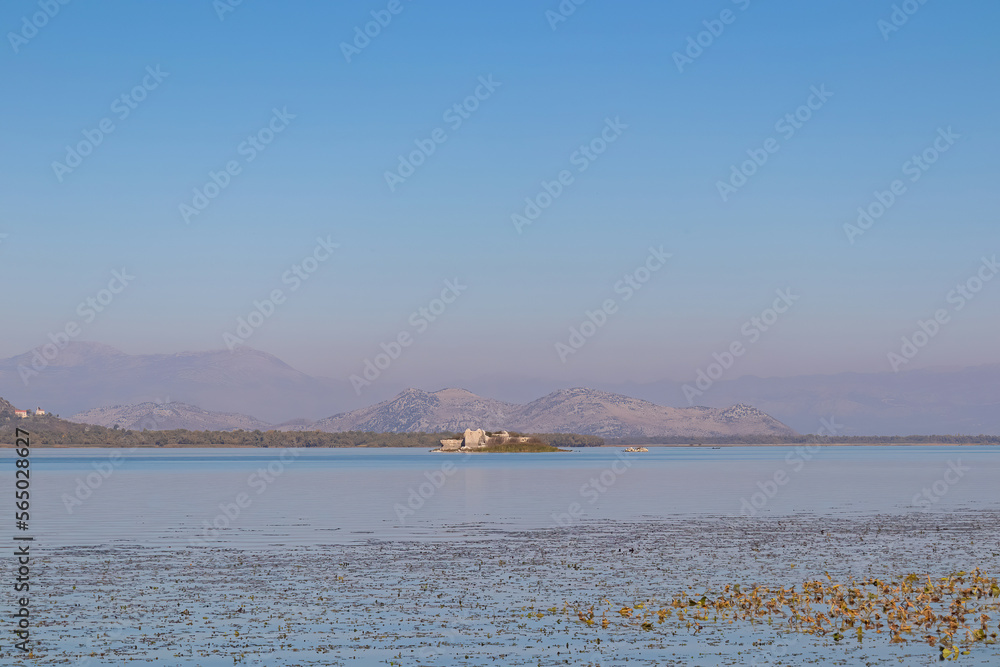 Panoramic view of ruins on Island Grmozur in Lake Skadar National Park in autumn seen from Godinje, Bar, Montenegro, Balkans, Europe. Travel destination in Dinaric Alps near the Albanian border Panoramic view of ruins on Island Grmozur in Lake Skadar National Park in autumn seen from Godinje, Bar, Montenegro, Balkans, Europe. Travel destination in Dinaric Alps near the Albanian border