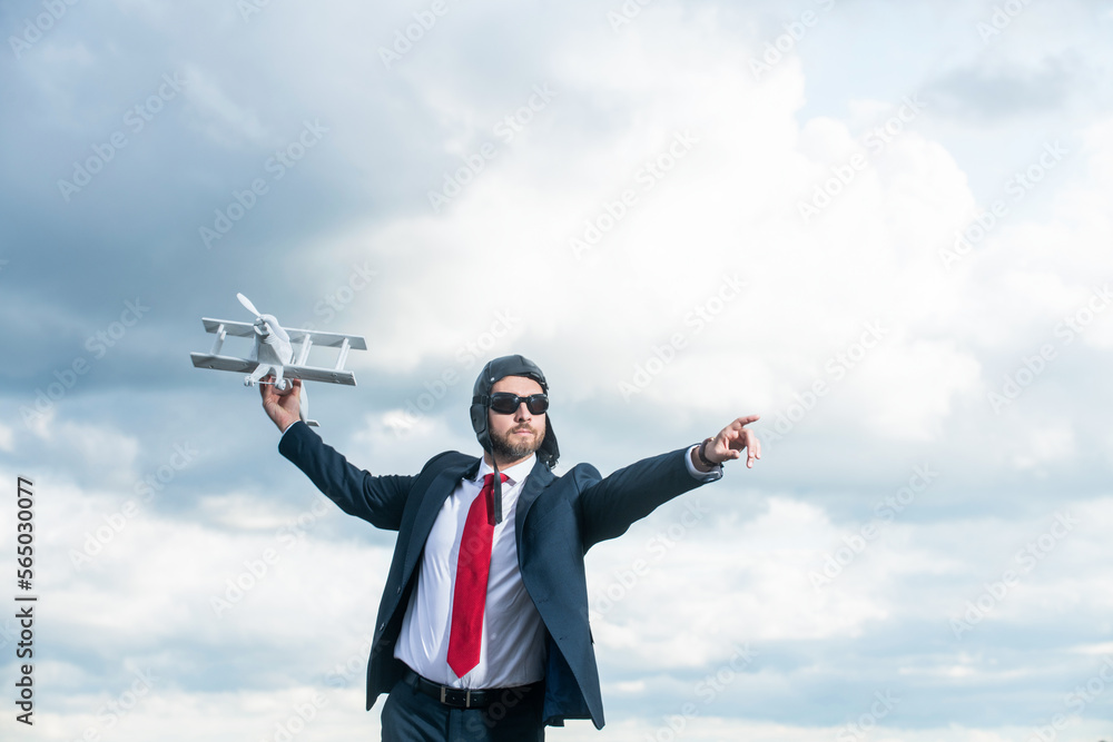 businessman in suit and pilot hat launch plane toy on sky background. opportunity businessman in suit and pilot hat launch plane toy on sky background. opportunity