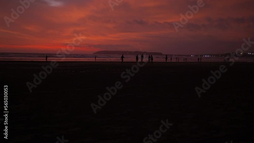 Wallpaper Mural Seascape view of people silhouettes on a sandy coastline, during a bright red sunset, on a cloudy evening Torontodigital.ca