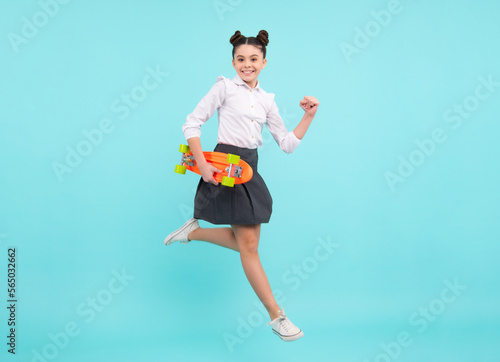 Teen hipster girl skater with skateboard on isolated background. Jump and run. Summer kids trend, urban teenage style.