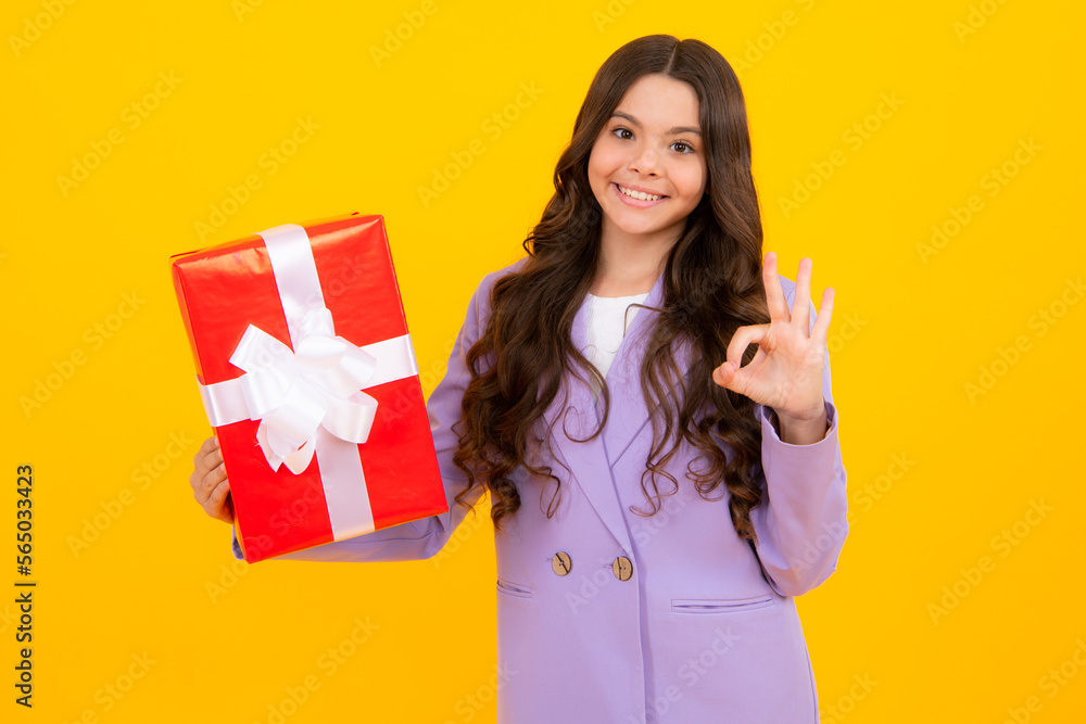 Teenager child holding gift box on yellow isolated background. Gift for kids birthday. Christmas or New Year present box. Valentines day. Teenager child holding gift box on yellow isolated background. Gift for kids birthday. Christmas or New Year present box. Valentines day.
