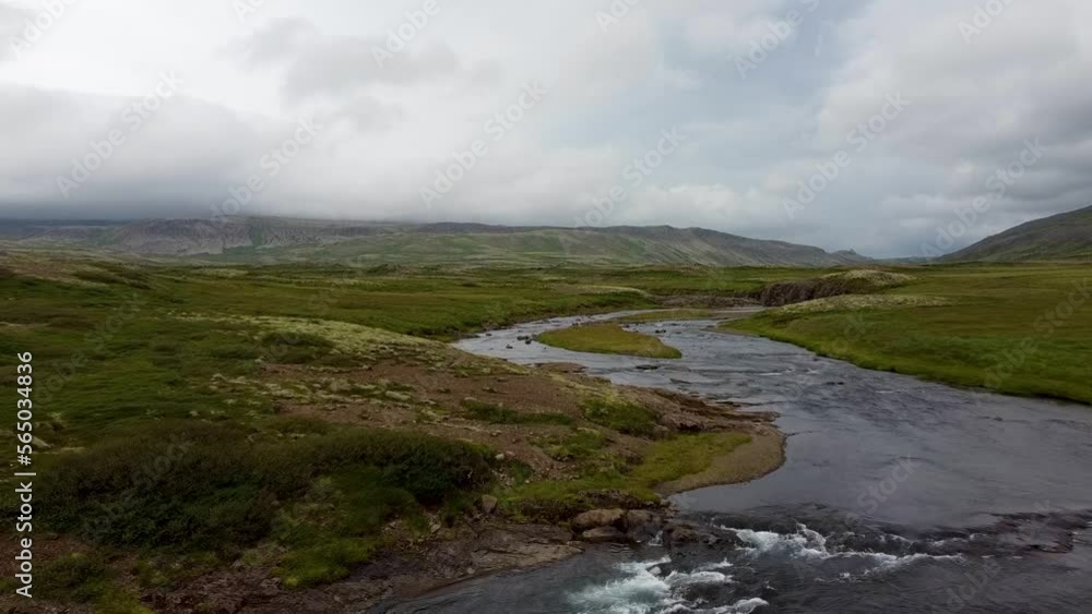 Curved river flowing on a flat land in Iceland on an overcast day, dolly in Curved river flowing on a flat land in Iceland on an overcast day, dolly in