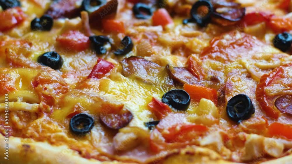close-up appetizing fresh pizza with cheese, olives, bacon, salami rotates. selective focus. pizzeria, italian cuisine restaurant. pizza delivery. fast food for lunch close-up appetizing fresh pizza with cheese, olives, bacon, salami rotates. selective focus. pizzeria, italian cuisine restaurant. pizza delivery. fast food for lunch