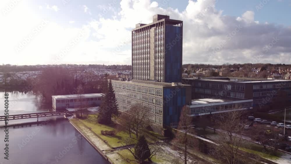 Aerial view Pilkington's glass head office and gardens, a modern blue high-rise with shared office space Aerial view Pilkington's glass head office and gardens, a modern blue high-rise with shared office space