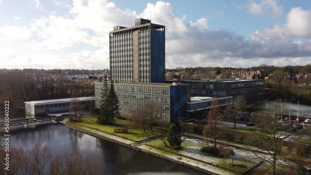 Aerial view Pilkington's glass head office, a modern blue high-rise with shared office space, dolly right Aerial view Pilkington's glass head office, a modern blue high-rise with shared office space, dolly right
