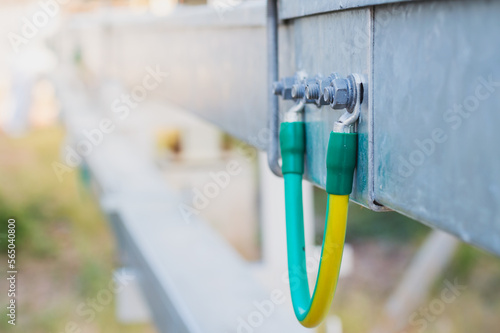 Electrical Wire way and Cable Ladder install at outdoor Area.Ground bonding cable between two Wire way .Ground Bonding for cable tray.Cable connected to electrical ground bar for safety photo