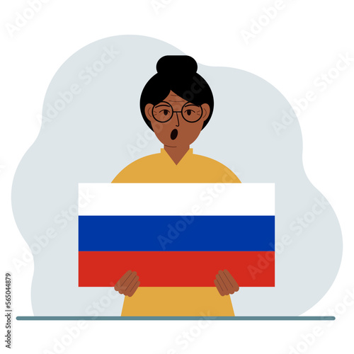 A woman holds a Russian flag in his hands. The concept of demonstration, national holiday or patriotism. Nationality.