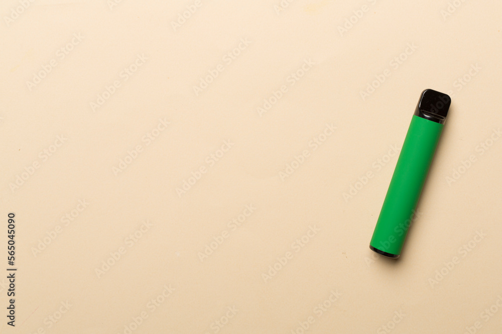 Disposable electronic cigarette on color background, top view Disposable electronic cigarette on color background, top view