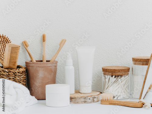 Bath background front view with straw box, personal accessories, cosmetics, jars and white towels on white background