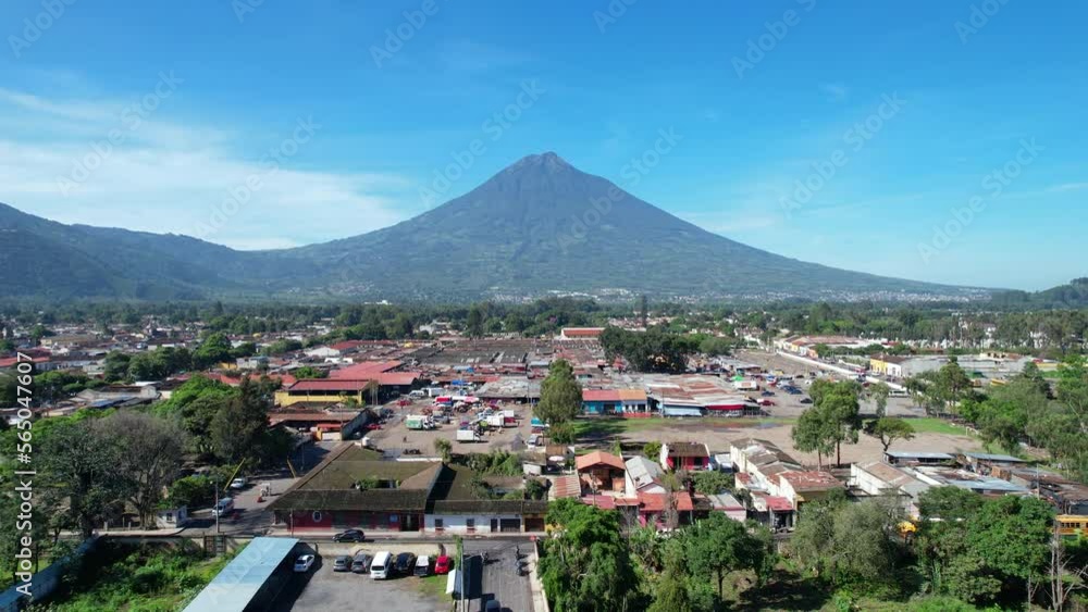 Aerial view of Antigua Guatemala by DJI air2s drone above the city, revealing beautiful architecture and landscape of the city. sunny sky volcano, Fuego, in the background. Aerial view of Antigua Guatemala by DJI air2s drone above the city, revealing beautiful architecture and landscape of the city. sunny sky volcano, Fuego, in the background.
