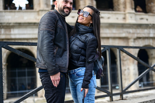 Happy  Tourists  couple traveling at Rome, Italy, poses in front of   Colosseum at, Rome, Italy.Concept of Italian travel.  © Striker777