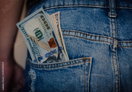 Money in my jeans pocket, 100 dollars in the back pocket of blue jeans. Wealth and prosperity concept. Place for text. Copy space