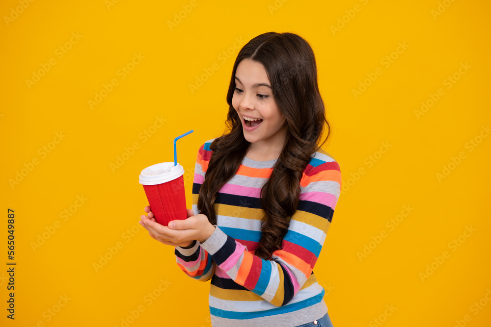 Teenage girl with take away cup of cappuccino coffee or tea. Child with takeaway cup on yellow background, morning drink beverage. Happy teenager, positive and smiling emotions of teen girl. Teenage girl with take away cup of cappuccino coffee or tea. Child with takeaway cup on yellow background, morning drink beverage. Happy teenager, positive and smiling emotions of teen girl.