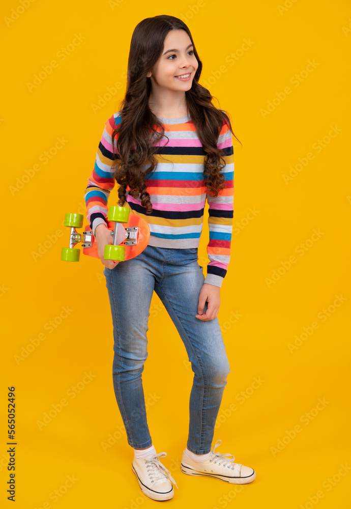 Studio shot of trendy teenage fashion model in casual look. Teenager youth hipster urban lifestyle. Child girl in street style with a skateboard. Happy teenager, smiling emotions of teen girl. Studio shot of trendy teenage fashion model in casual look. Teenager youth hipster urban lifestyle. Child girl in street style with a skateboard. Happy teenager, smiling emotions of teen girl.