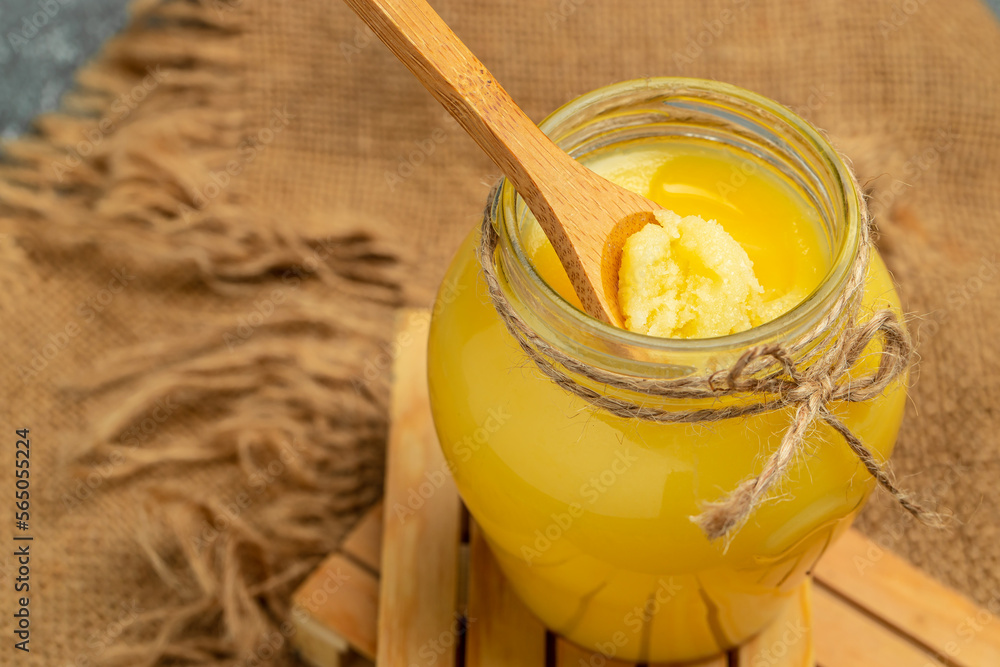 ghee oil. Ghee or clarified butter in jar on a wooden background. banner, menu, recipe place for text ghee oil. Ghee or clarified butter in jar on a wooden background. banner, menu, recipe place for text