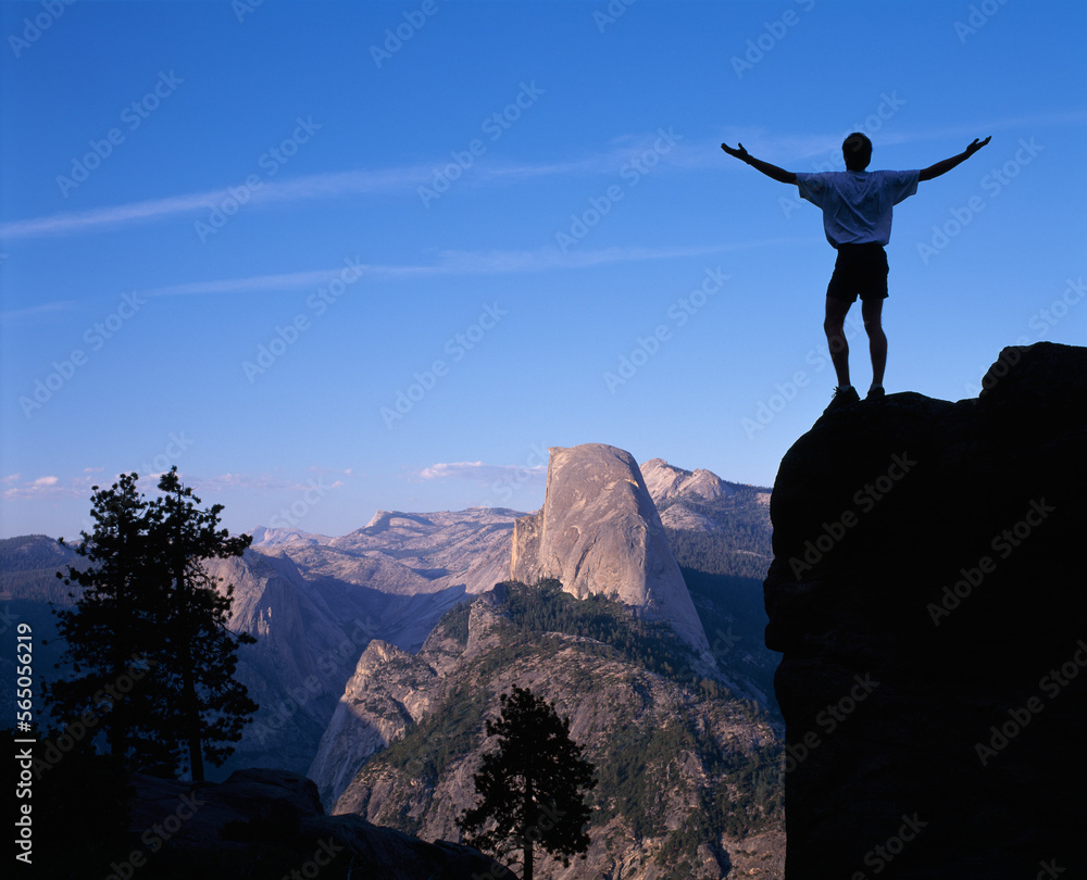 Hiker Overlooking Half Dome, Yosemite National Park, California, USA Hiker Overlooking Half Dome, Yosemite National Park, California, USA